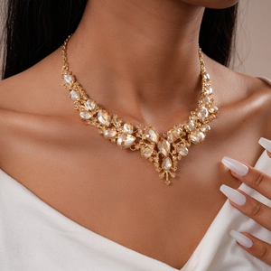 Close-up of luxury champagne crystal floral necklace set worn on a model's collarbone