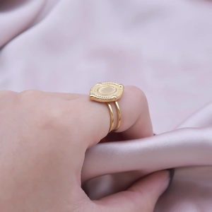 Detailed view of an 18K gold-plated stainless steel double-band ring with a vintage oval disc
