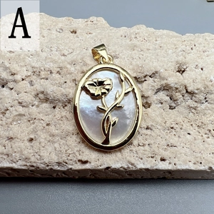 Detailed view of oval flower pendant with iridescent mother of pearl and golden frame