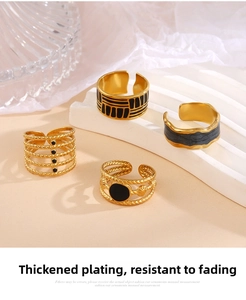 Detail of adjustable gold rings with black enamel inlay and geometric patterns
