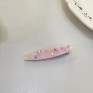 Detailed shot of pink resin star hair clip with colorful butterfly sequins and glitters