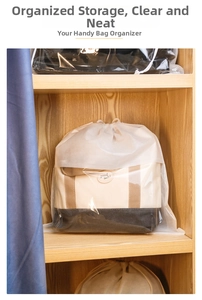 Detailed view of dustproof storage bag with drawstring in a wooden wardrobe setting