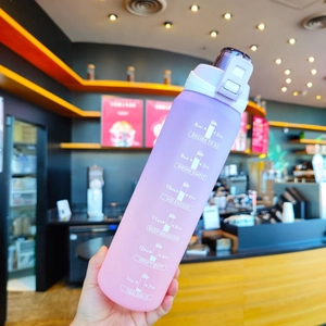 Detail of the purple-to-pink gradient frosted sports bottle with handle and scale