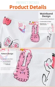 Detail of girls' white ribbed knit flare leggings with cute pink bunny embroidery