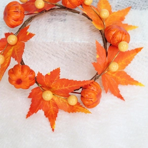 Autumn wreath with orange maple leaves, mini pumpkins and berries for Thanksgiving decor