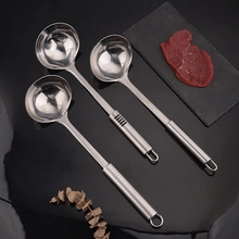 Polished 430 stainless steel whisk set in various sizes shown on a dark background