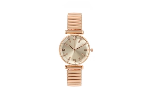 Close-up of rose gold watch with Roman numerals, rhinestones, and elastic metal band