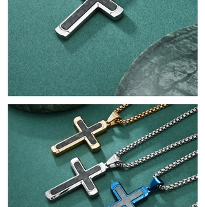Macro detail of cross pendants in gold, silver and blue steel with black carbon fiber inlay