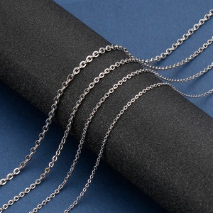 Detailed macro shot of stainless steel O-chain necklaces in various sizes on a black stand