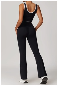 Rear view of black high-waisted yoga set featuring contrast piping and deep U-back design