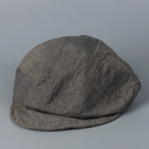 Detail shot of distressed breathable linen texture and stitching on an irregular flat cap