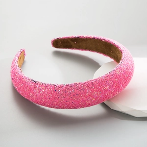 Close-up of padded pink headband with sparkling sequins and brown non-slip lining