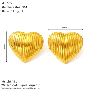 Detail view of 18k gold plated heart earrings with 22x25mm size and material specs