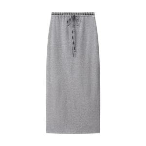 Detail of grey knitted maxi skirt with drawstring waist and plaid interior lining texture