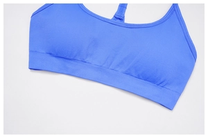 Detail of bright blue seamless knit sports bra with ribbed hem and racerback design