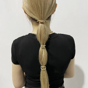 Three-piece minimalist gold metallic ponytail hair cuff set with a polished mirror finish