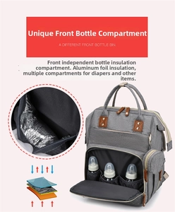 Detail of insulated front pockets with aluminum foil lining for baby bottles in gray bag