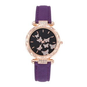 Detail of purple leather strap watch with butterfly dial and rhinestone bezel
