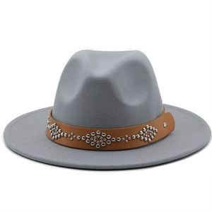 Detail of grey wool fedora hat featuring a brown faux leather band with silver rivets