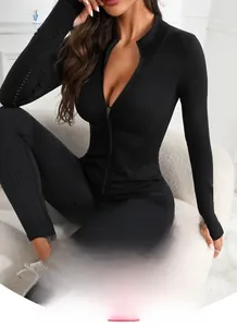 Close-up of black breathable mesh fabric with front zipper and thumb holes on yoga jacket
