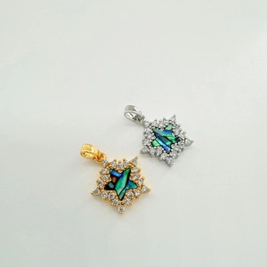 Macro shot of 18k gold plated star pendant with natural shell inlay and white zircon stones
