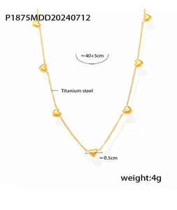 Macro detail of gold titanium steel necklace featuring multiple heart pendants