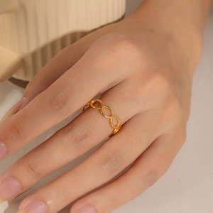 Close-up of minimalist 18k gold plated stainless steel irregular chain link ring on finger