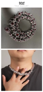 Close-up of hip hop dragon necklace with thorny red eyes and sparkling crystal accents