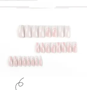 Detailed view of French tip press-on nails with white glitter waves and pink base