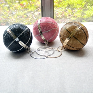 Detailed shot of basketball-shaped rhinestone purses in black, pink, and gold metallic finishes