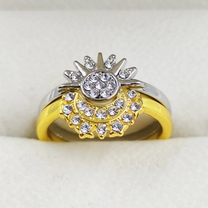 Macro detail of sun and moon stacking rings with sparkling pavé crystal settings