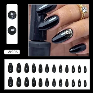 Detail of almond black press-on nails with silver glitter gradient and glossy finish