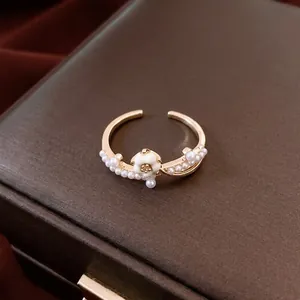 14K gold plated flower and pearl open ring displayed on a premium leather jewelry box