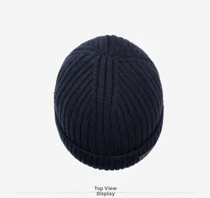 Top down view of navy blue ribbed knit beanie with small decorative side label