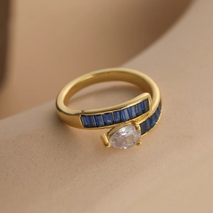 Minimalist gold plated copper ring with blue zircon and pear-shaped clear gemstone
