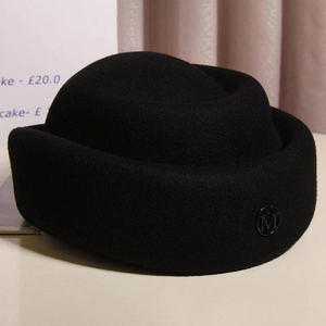 Elegant vintage Audrey Hepburn style wool felt pillbox hat in black with metal M logo