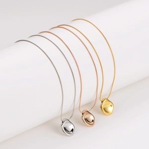 Minimalist irregular concave pendant necklace set in gold, silver, and rose gold finishes