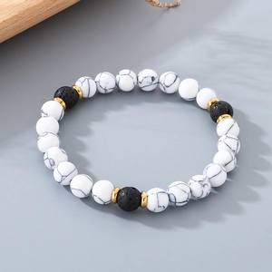 Detail view of 8mm white turquoise and black volcanic lava stone beaded elastic bracelet