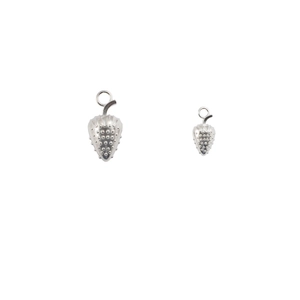 Macro detail of small and large silver strawberry charms for DIY jewelry making