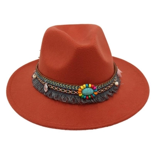 Dettaglio della fascia etnica intrecciata con perline turchesi e frange sul cappello fedora