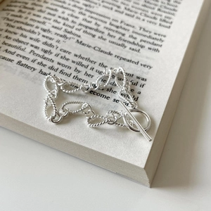 Macro shot of 925 sterling silver twisted chain bracelet with a classic T-bar toggle clasp