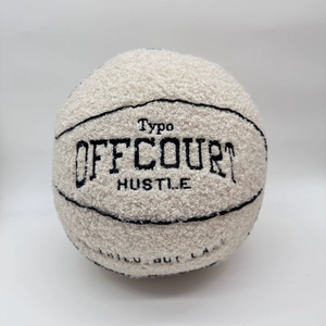 Detail of the Offcourt basketball plush pillow showing soft cream bouclé fabric texture