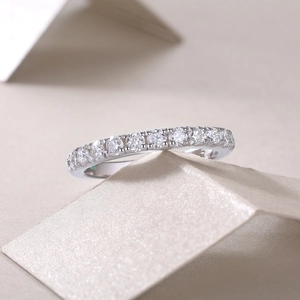 Macro detail of elegant silver S925 sterling silver half eternity ring with round gemstones