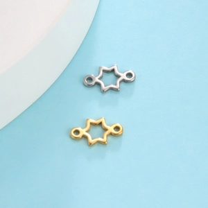 Gold and silver star-shaped stainless steel charms for jewelry making on blue backdrop