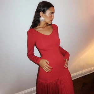 Detail of red slim fit V-neck dress showing waist pleats and long sleeve knitted texture