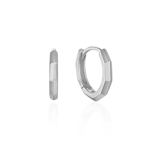 Macro detail of geometric faceted S925 sterling silver hoop earrings with mirror reflection