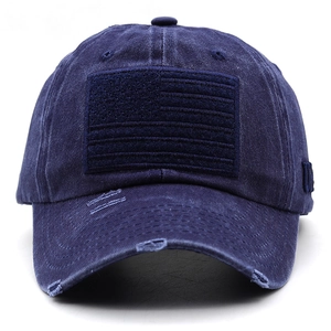 Close-up of distressed brim and monochrome flag embroidery on navy washed cotton cap