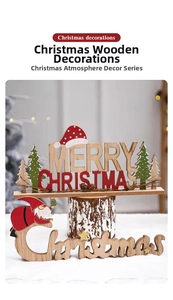 Close-up of Merry Christmas wooden table ornaments with Santa and tree motifs