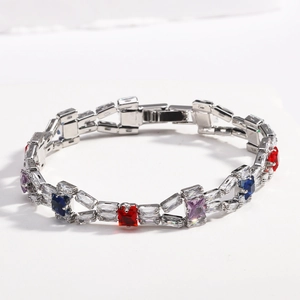 Macro shot of silver tennis bracelet with colorful gemstones and white zircon pave setting