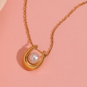 Close-up of 18K gold plated U-shaped necklace pendant with a round white pearl